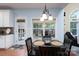 Breakfast nook featuring wood table, window with natural light, and door to the outside at 201 Vanderbilt Blvd, Locust, NC 28097