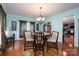 This elegant dining room features hardwood floors, wainscoting, and a stylish chandelier at 201 Vanderbilt Blvd, Locust, NC 28097