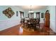 This dining room offers stylish seating, hardwood floors, and a decorative wall piece at 201 Vanderbilt Blvd, Locust, NC 28097