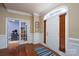 Inviting foyer with hardwood floors, white wainscoting, and entry door with transom window at 201 Vanderbilt Blvd, Locust, NC 28097