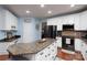 Spacious kitchen island featuring granite countertops, stainless appliances, and hardwood floors at 201 Vanderbilt Blvd, Locust, NC 28097