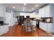 Open kitchen with white cabinets, granite countertops, stainless steel appliances, and hardwood floors at 201 Vanderbilt Blvd, Locust, NC 28097