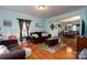 Cozy living room featuring hardwood floors, soft blue walls and an opening into the dining room at 201 Vanderbilt Blvd, Locust, NC 28097