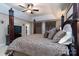 This spacious main bedroom features a tray ceiling, large windows, and a luxurious bed with decorative pillows at 201 Vanderbilt Blvd, Locust, NC 28097