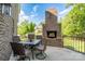 Back patio with an outdoor brick fireplace and dining table that is perfect for entertaining at 201 Vanderbilt Blvd, Locust, NC 28097