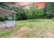 Large, grassy backyard with mature trees providing shade and privacy at 205 Stowe Acres Rd, Kings Mountain, NC 28086