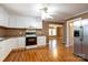 Kitchen with white cabinets, laminate flooring, and an adjoining room at 205 Stowe Acres Rd, Kings Mountain, NC 28086