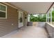 Covered patio with concrete flooring and vinyl siding offers outdoor living space at 205 Stowe Acres Rd, Kings Mountain, NC 28086