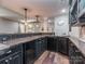 Stylish basement bar area featuring a dark countertop, wood cabinets, and ample space for entertaining guests at 2301 Keara Way, Charlotte, NC 28270