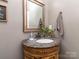 Elegant bathroom with a carved vanity, marble countertop, and decorative mirror enhancing its upscale appeal at 2301 Keara Way, Charlotte, NC 28270