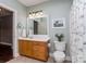 Well-lit bathroom with a vanity, framed mirror, and a shower with a decorative curtain at 2301 Keara Way, Charlotte, NC 28270
