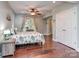 Serene bedroom with soft colors, a ceiling fan, and ample natural light from the window at 2301 Keara Way, Charlotte, NC 28270