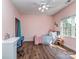 Cozy bedroom featuring a ceiling fan, a window offering plenty of natural light, and hardwood floors at 2301 Keara Way, Charlotte, NC 28270