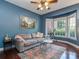 Blue living room with bay window, telescope, hardwood floors and neutral-colored furniture at 2301 Keara Way, Charlotte, NC 28270