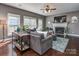 Cozy living room with plush gray sectional sofa, white fireplace and hardwood floors at 2301 Keara Way, Charlotte, NC 28270