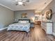 Open main bedroom features a ceiling fan, hard wood floors, sitting area, and en suite bathroom at 2301 Keara Way, Charlotte, NC 28270