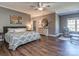 Spacious main bedroom with hardwood floors, neutral colors, and a ceiling fan at 2301 Keara Way, Charlotte, NC 28270