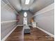 Spacious walk-in closet with custom shelving, hardwood floors, neutral colors and an ottoman at 2301 Keara Way, Charlotte, NC 28270