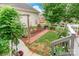 Backyard with brick patio and lush greenery provides a private outdoor retreat at 23128 Goose Down Ln, Lancaster, SC 29720