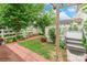 Landscaped backyard with brick path, and pergola offers a serene outdoor oasis at 23128 Goose Down Ln, Lancaster, SC 29720