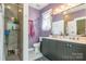 Stylish bathroom featuring double vanity, walk-in shower with glass enclosure, and plenty of natural light at 23128 Goose Down Ln, Lancaster, SC 29720