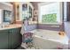 Inviting bathroom with whirlpool tub, vanity with sink, and decorative features at 23128 Goose Down Ln, Lancaster, SC 29720