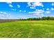 Large, fenced-in backyard features lush green grass and a wooded area in the distance at 2322 Joes Lake Rd, Shelby, NC 28152