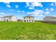Expansive backyard view featuring lush green grass and neighboring homes, partially fenced in at 2322 Joes Lake Rd, Shelby, NC 28152