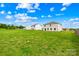 Vast backyard showing well-maintained grass with neighboring homes and partial fencing at 2322 Joes Lake Rd, Shelby, NC 28152