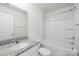 Well-lit bathroom showcasing granite vanity and a shower-tub combination at 2322 Joes Lake Rd, Shelby, NC 28152