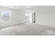 Well-lit bedroom with neutral carpet, large windows, and an open door to an ample closet space at 2322 Joes Lake Rd, Shelby, NC 28152