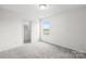 Bright bedroom with soft carpet, a window view, and access to a closet at 2322 Joes Lake Rd, Shelby, NC 28152