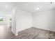 Bright, open-concept living room with sleek wood-look flooring and fresh white paint at 2322 Joes Lake Rd, Shelby, NC 28152