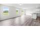 Open-concept living area with sliding glass doors, wood floors, and a breakfast bar at 2322 Joes Lake Rd, Shelby, NC 28152