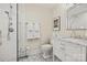 Modern bathroom with white cabinets, marble countertop, shower and hexagon tile flooring at 2329 Club Rd, Charlotte, NC 28205