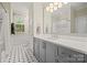Elegant bathroom featuring black and white tile floors, a spacious vanity, and a shower tub at 2329 Club Rd, Charlotte, NC 28205