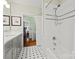 Clean bathroom boasting a tub and shower combo and white tile, complemented by a gray vanity with modern fixtures at 2329 Club Rd, Charlotte, NC 28205