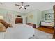 Spacious bedroom with a large patterned rug, hardwood floors, and neutral-colored furniture at 2329 Club Rd, Charlotte, NC 28205