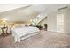 Bright and airy bedroom with a dormer window, a work area and a comfortable seating area at 2329 Club Rd, Charlotte, NC 28205