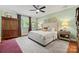 Cozy bedroom with a large bed, patterned headboard, and mint green painted walls at 2329 Club Rd, Charlotte, NC 28205