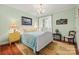 Light and airy bedroom with charming décor, a soft color palette, and a cozy rug at 2329 Club Rd, Charlotte, NC 28205