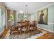 Elegant dining room with stylish chandelier, a zebra rug, and views to the backyard at 2329 Club Rd, Charlotte, NC 28205