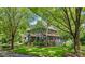 Beautiful home with lush landscaping and mature trees providing shade and curb appeal at 2329 Club Rd, Charlotte, NC 28205