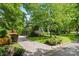 Charming home with lush landscaping, a long driveway, and a detached garage at 2329 Club Rd, Charlotte, NC 28205