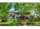 Charming two-story home with a well-manicured lawn and mature trees at 2329 Club Rd, Charlotte, NC 28205