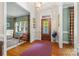 Warm and welcoming foyer featuring hardwood floors and a stained-glass front door at 2329 Club Rd, Charlotte, NC 28205