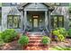 Inviting front porch with brick steps and dark columns at 2329 Club Rd, Charlotte, NC 28205