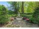 Charming garden area with decorative fountain, surrounded by lush greenery and comfortable seating at 2329 Club Rd, Charlotte, NC 28205