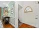 Inviting hallway featuring hardwood floors, decorative mirrors, and an open view of the staircase at 2329 Club Rd, Charlotte, NC 28205