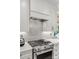 Close-up of a kitchen range with stainless steel appliances and white cabinetry at 2329 Club Rd, Charlotte, NC 28205